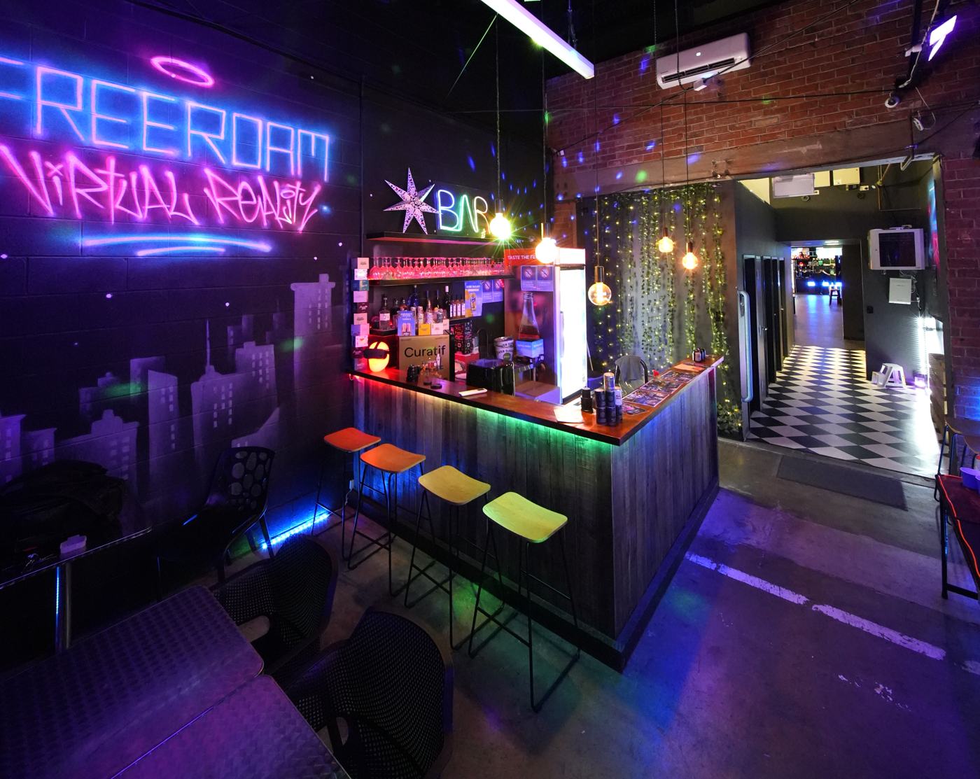 The AfterDark Social bar — neon graffiti, Edison bulbs and the ★BAR sign